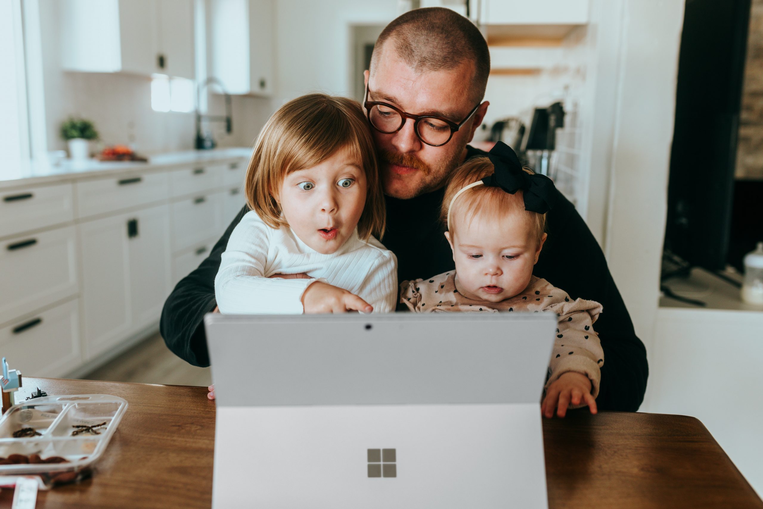 Family learning cybersecurity together on a laptop
